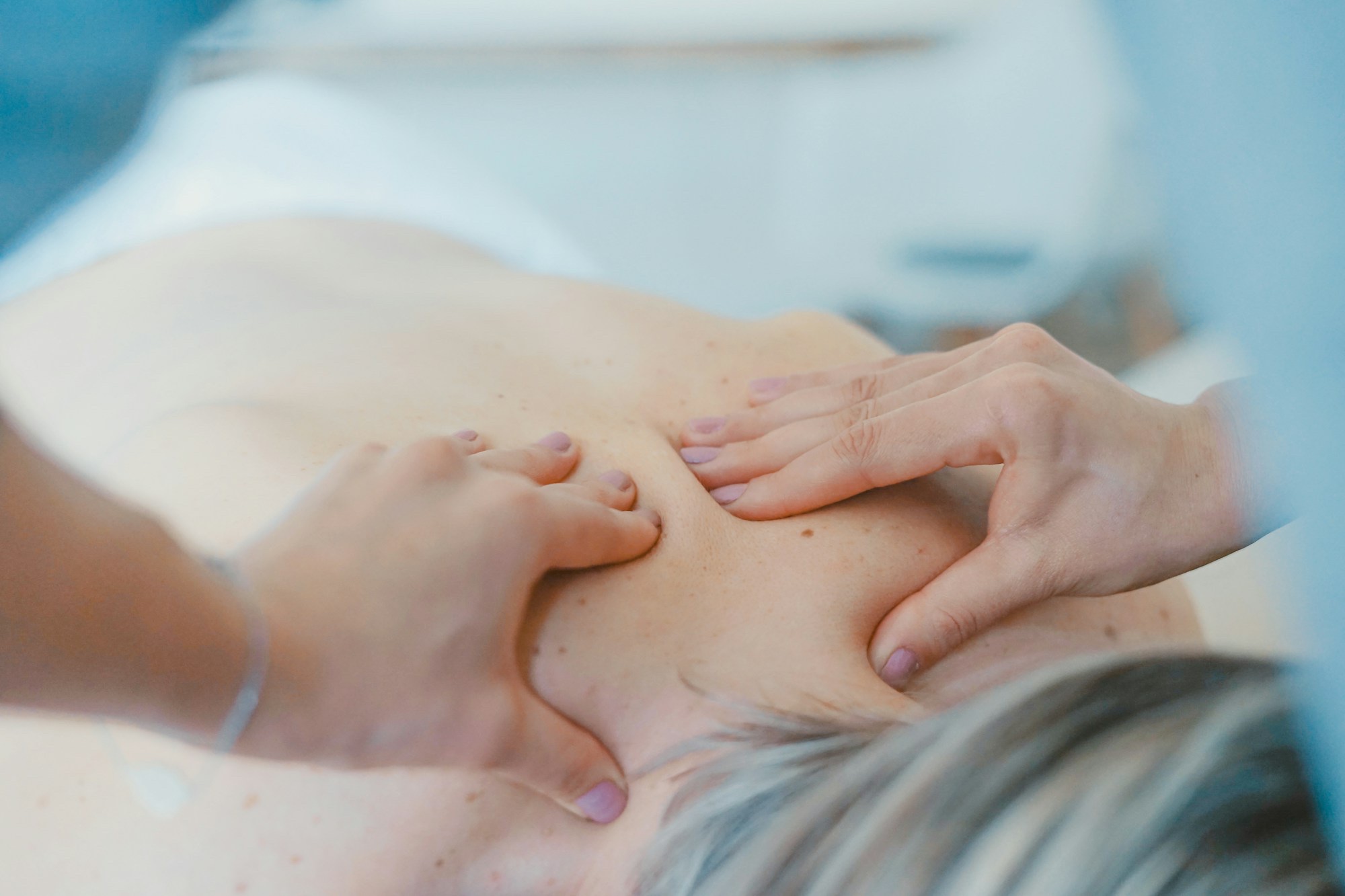 Therapist hands performing manual therapy on a client at Hands-On Wellness OT